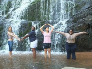 women at waterfall